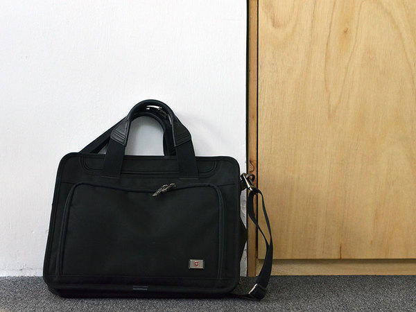 Laptop bag resting against a wall